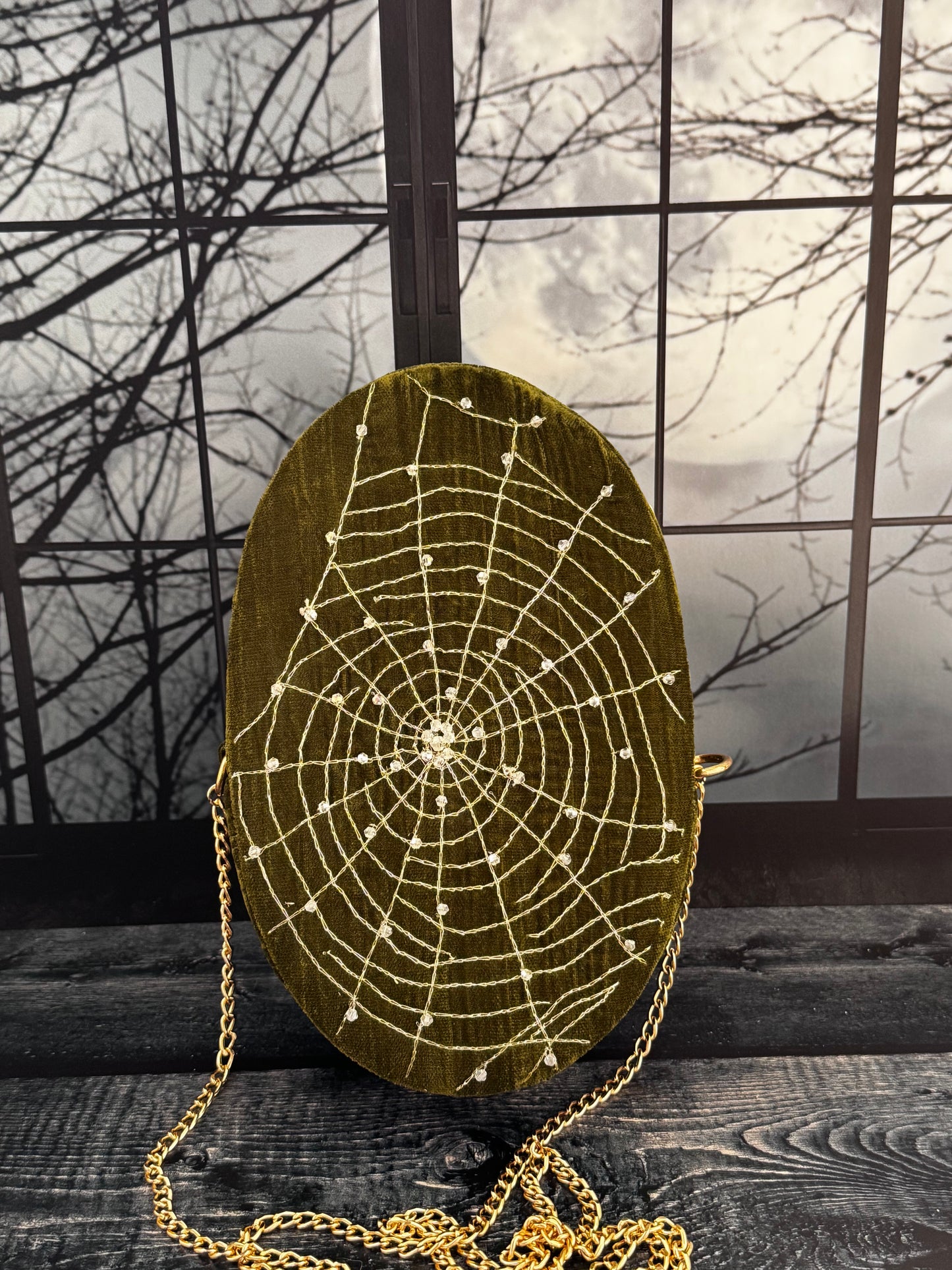 Moss & Moonlight forest green velvet purse, front view with hand embellished gold spiderweb and chain strap
